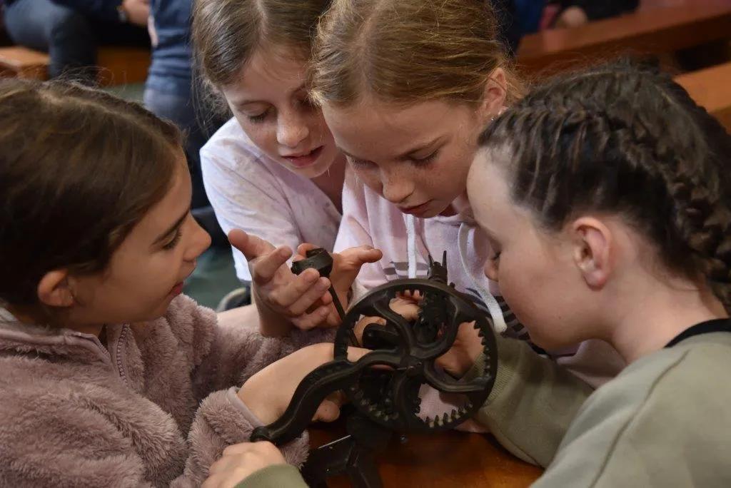 Children playing with a gear