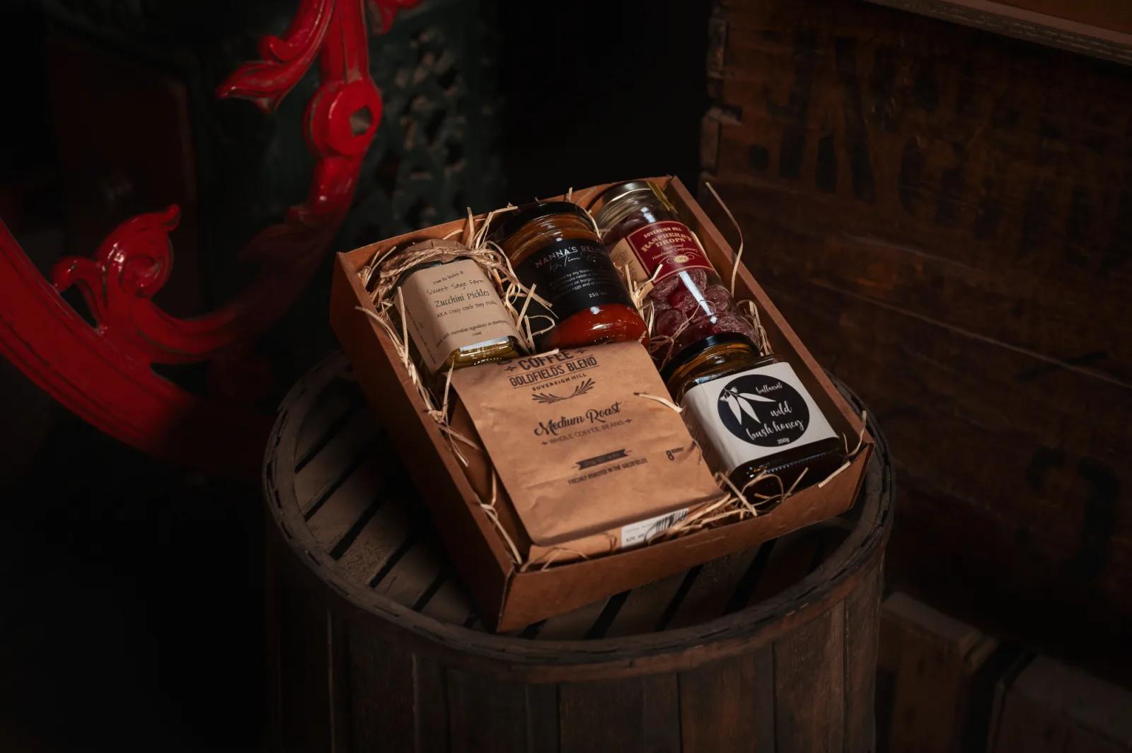 A rustic still-life photograph featuring a gift basket