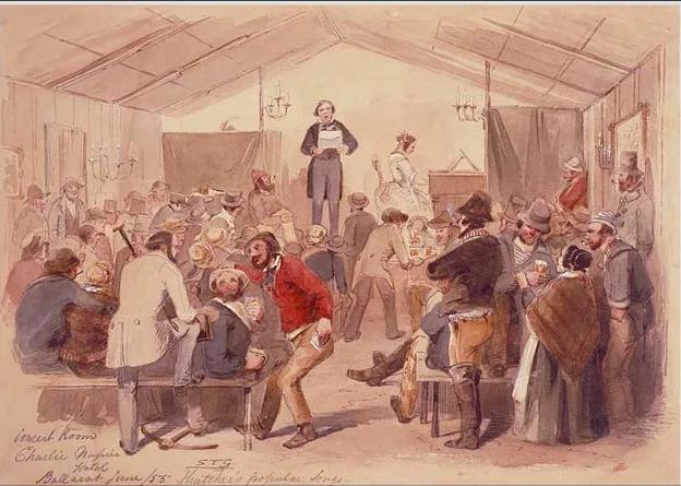 A lively 19th-century watercolour depicts the Charlie Napier Concert Room a bustling gold rush-era entertainment venue where a performer stands on a raised platform addressing a crowded, animated audience in period dress. Men and women gather around tables, some drinking, others conversing or listening intently, under gas-lit chandeliers and draped curtains. This scene, titled “Charlie Napier’s Hotel, Ballarat, June 1858 – ‘Matteo’s popular song’”, is preserved and interpreted at Sovereign Hill to illustrate the vibrant social life of the era.