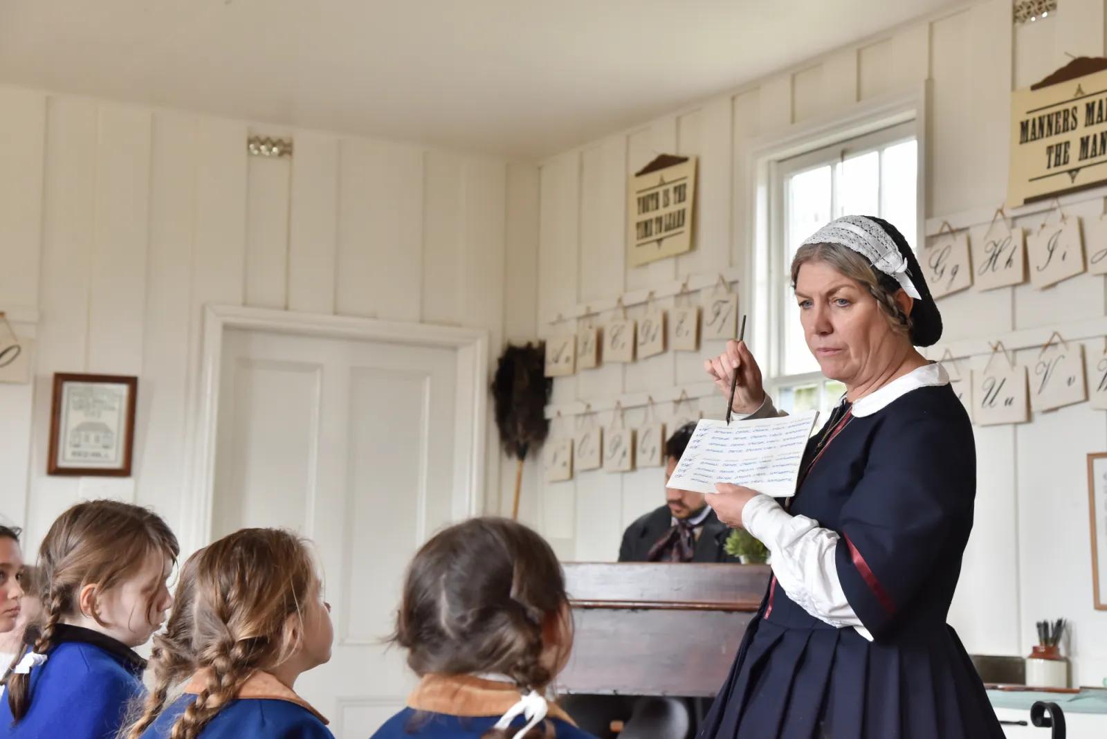 Children learning in a classroom from a teacher