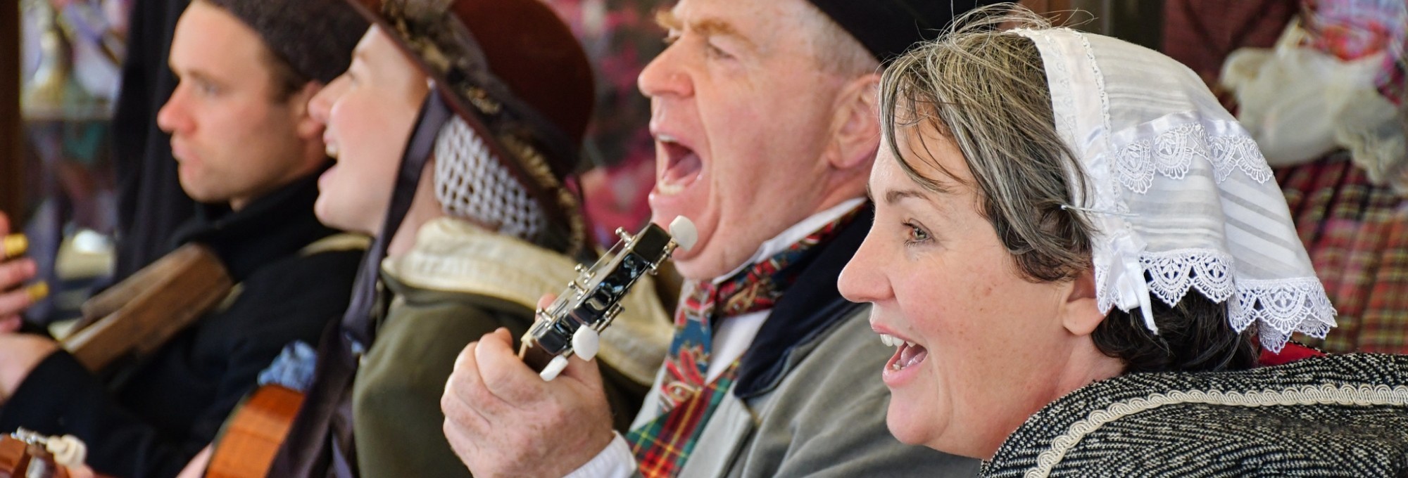 People in costume singing and playing instruments