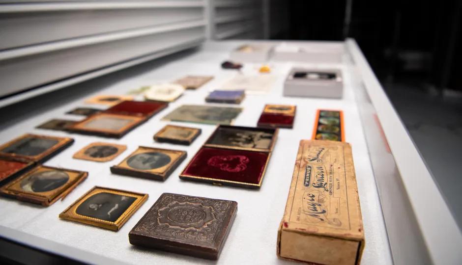 Collection of historical items at the Australian Centre for Gold Rush Collections, showcasing old photographic techniques and artifacts in a museum storage drawer.