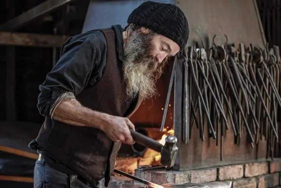 Blacksmith with a hammer and anvil